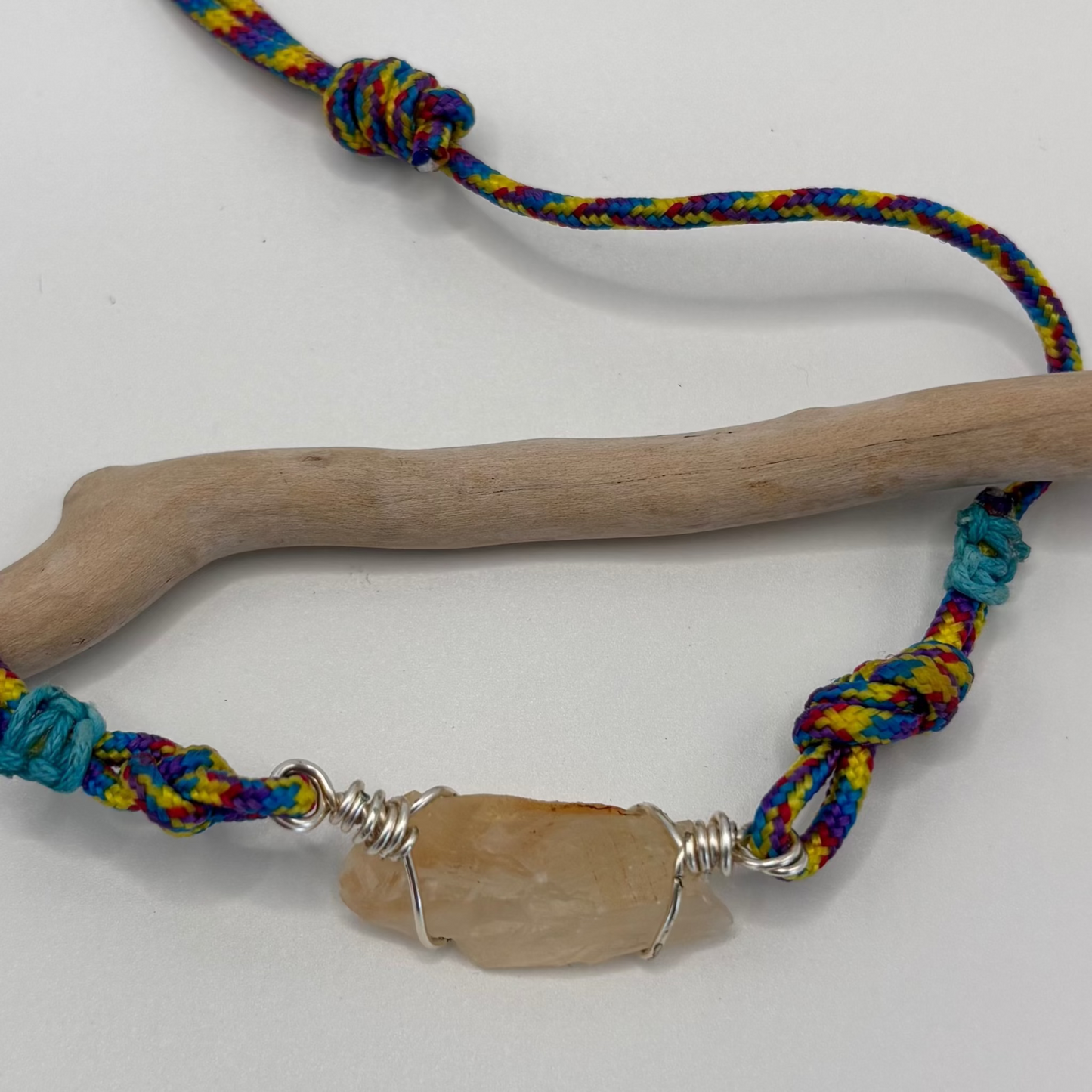 Close-up of calcite pendant wire wrap detail on cord necklace