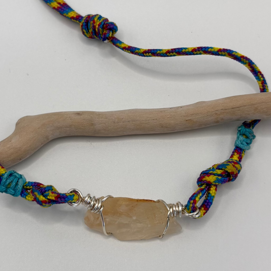 Close-up of calcite pendant wire wrap detail on cord necklace