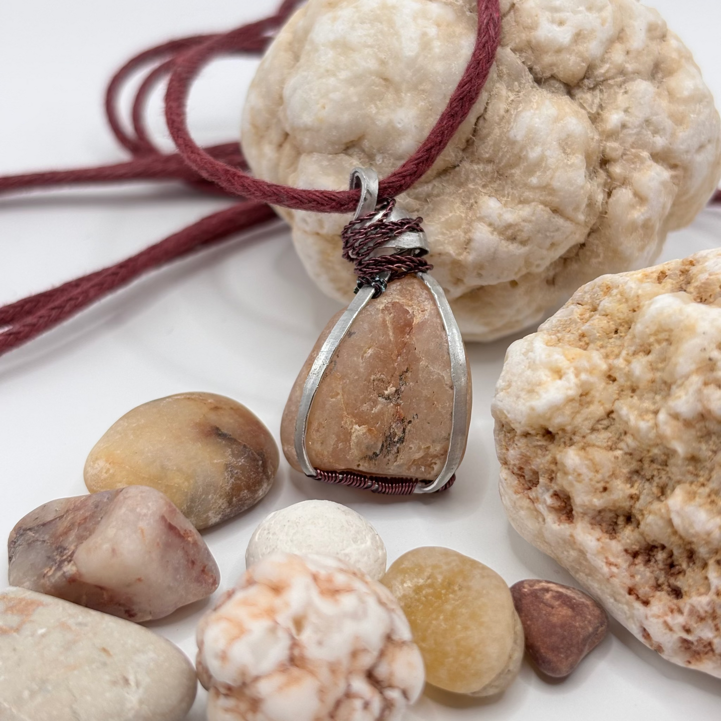 Raw pink-toned Aegean stone wrapped in aluminum wire pendant necklace