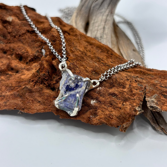 silver Necklace with a blue tanzanite raw stone pendant on a piece of baobab tree. handmade