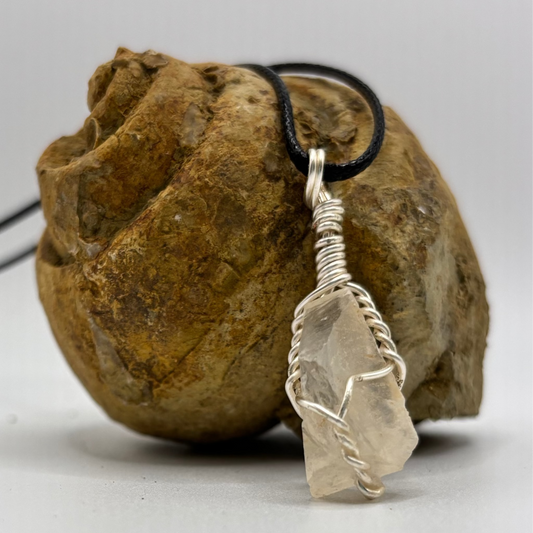 Close-up of wire wrapped calcite stone showing translucent glow
