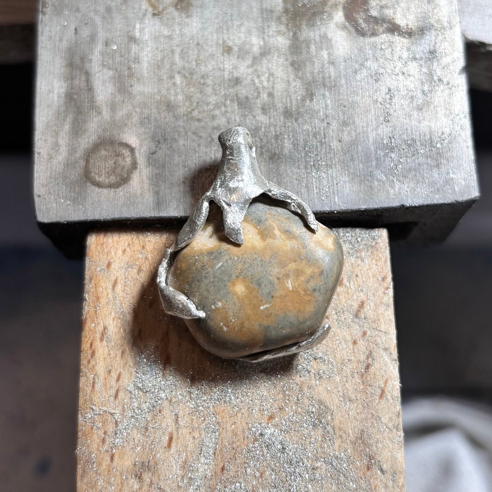 grey and brown oval beach stone pendant silver wavy claw setting 7ajra