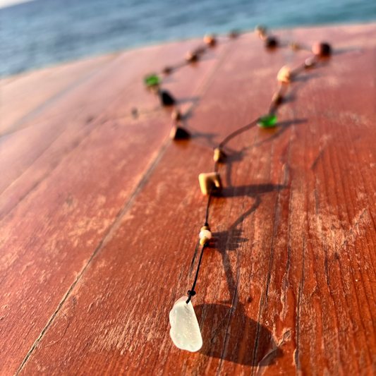 Close-up of a 7ajra necklace made with twelve raw stones, each uniquely shaped and textured.