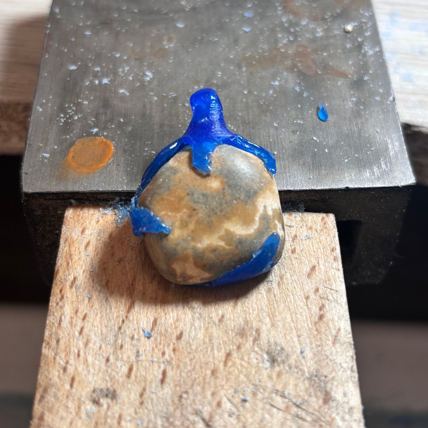 grey and brown oval beach stone pendant in wax form with wavy claw setting 7ajra