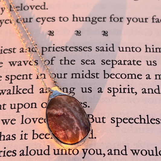 Beach stone wrapped in organic flowing silver, handmade pendant