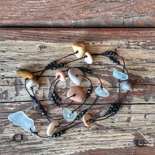 Necklace with sea glass and beads on a wooden surface