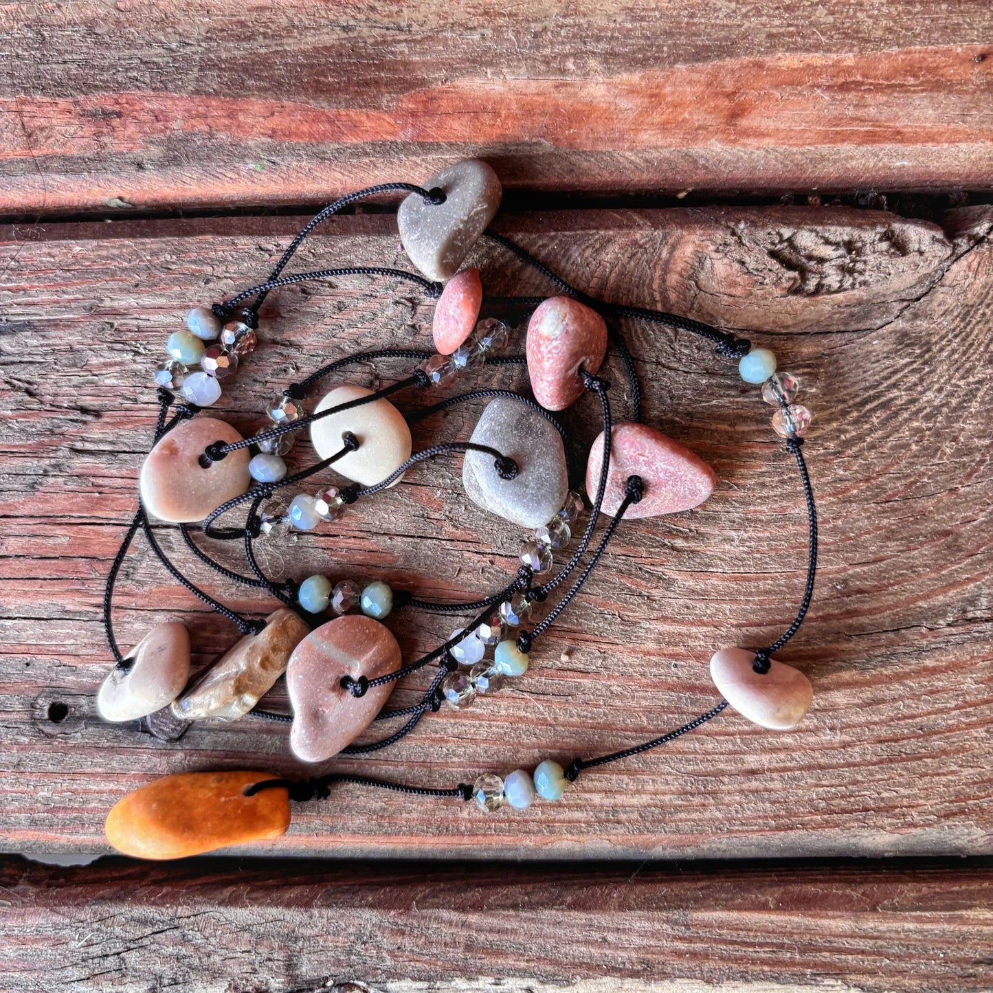 Bracelet with heart-shaped stones on a wooden surface