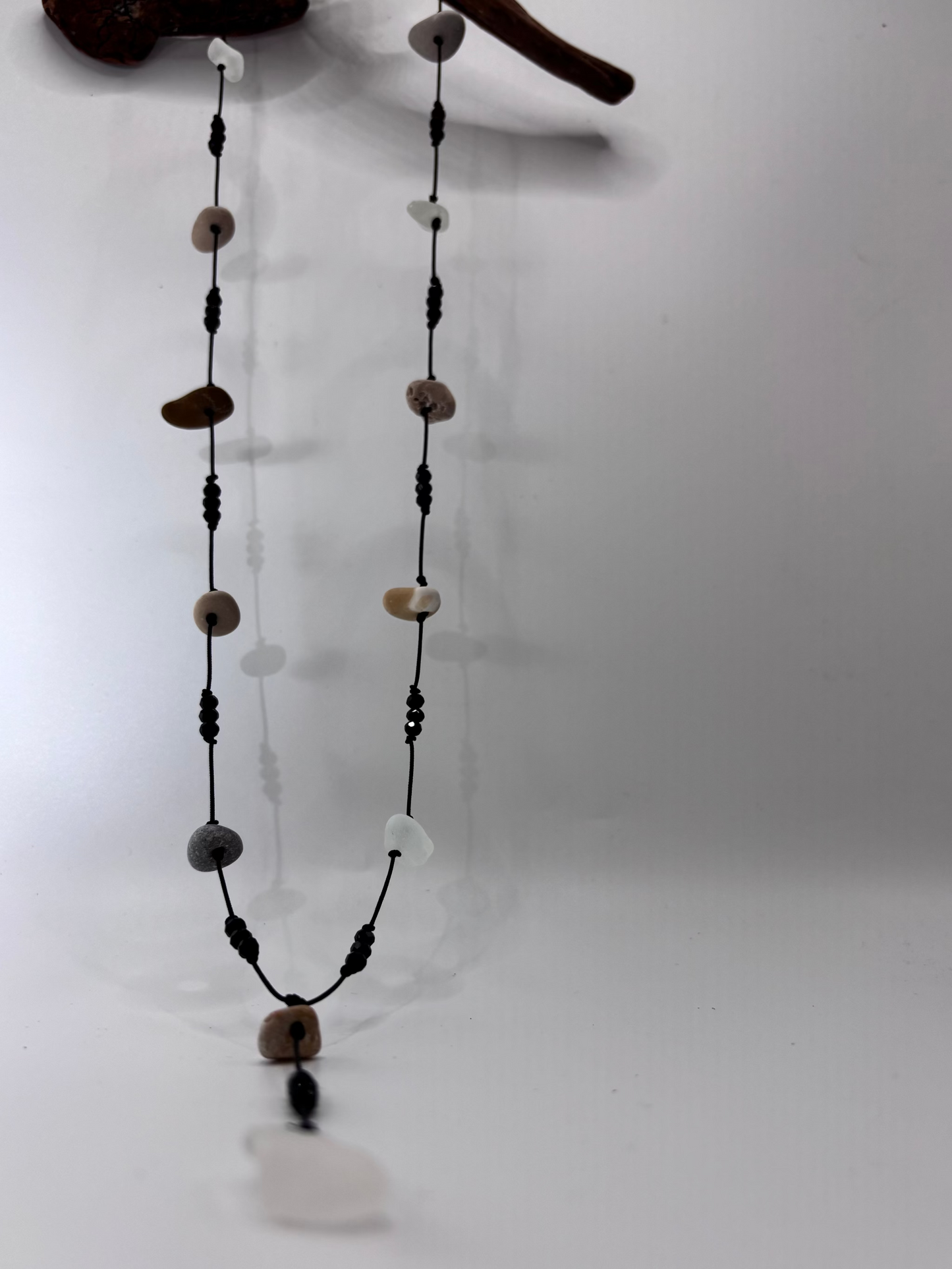 black lariat style with beach stones
