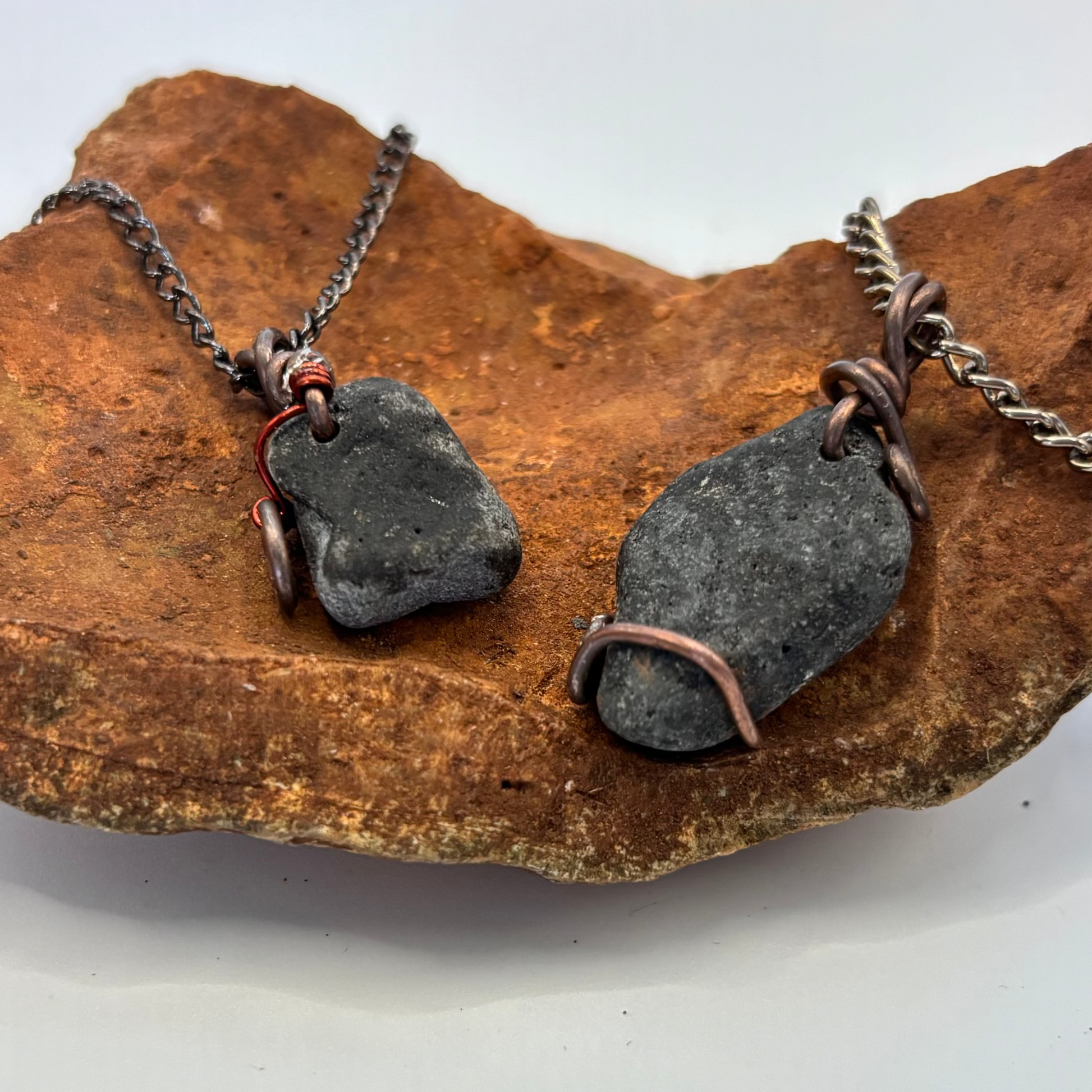 Raw black stone pendant close-up showing natural texture