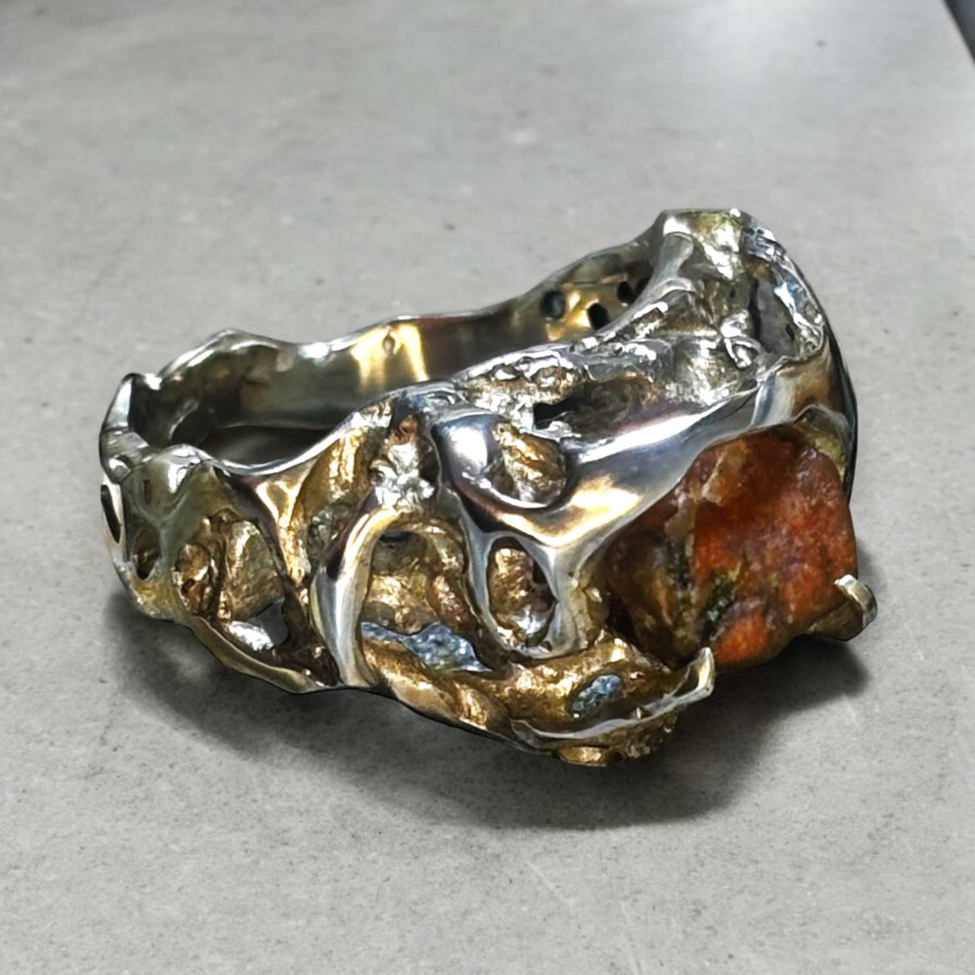 Clessidera ring photographed against a neutral background