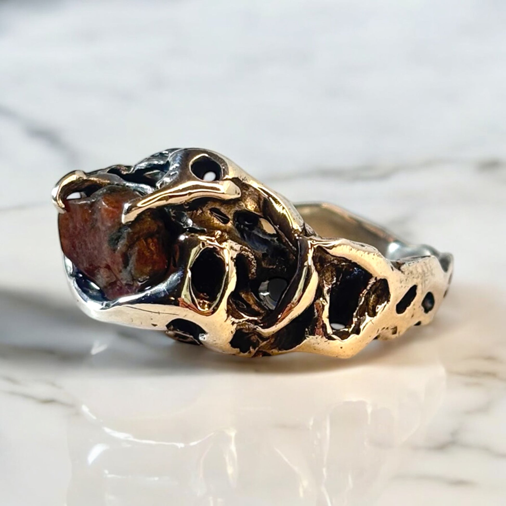 Raw stone from Norway's fjords held in silver claws