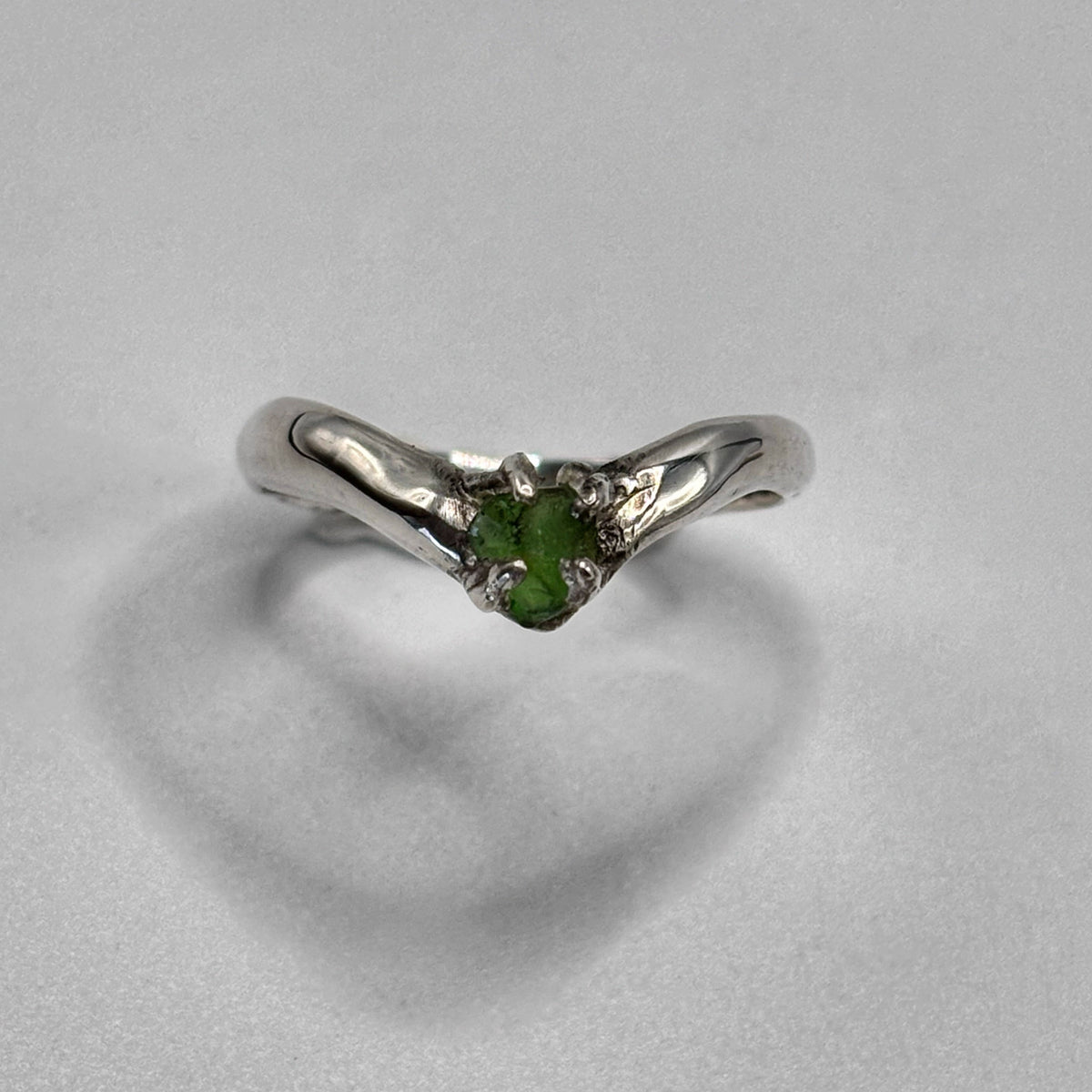 Close-up of sea glass set in silver crown ring-shaped ring