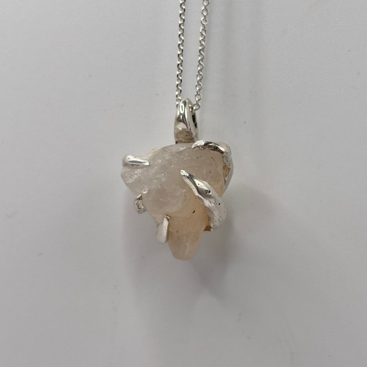 Dragonite sterling silver pendant with claw-set coastal stone