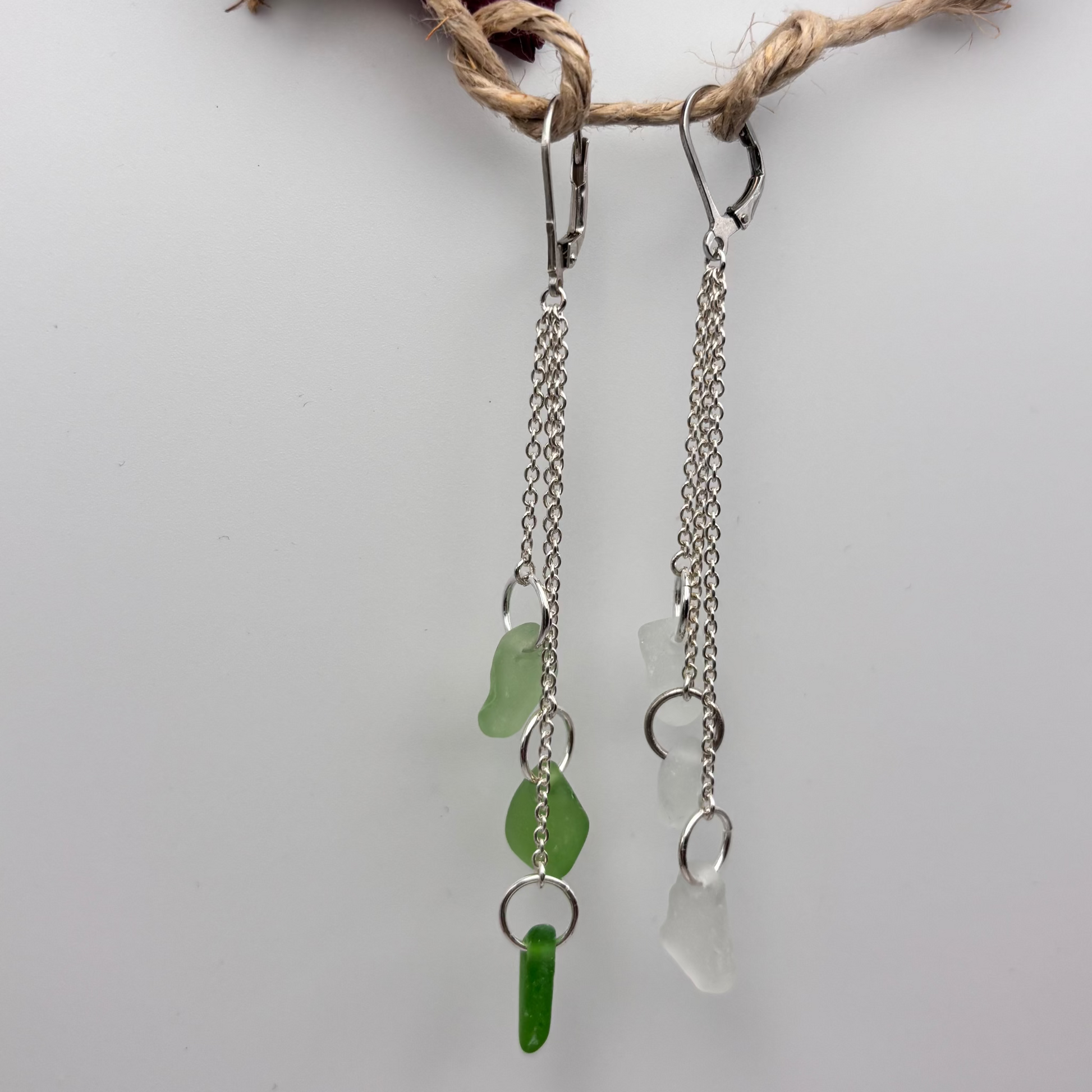 Emerald Drift and Mediterranean Spray earrings, green and white sea glass pair on silver chains.