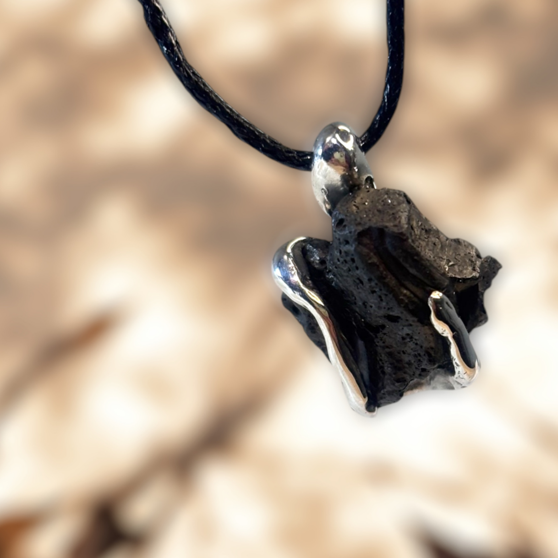 Raw iron ore stone set in hand-sculpted silver pendant