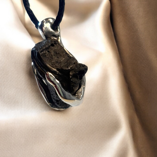 Close-up of iron ore pendant showing silver setting detail