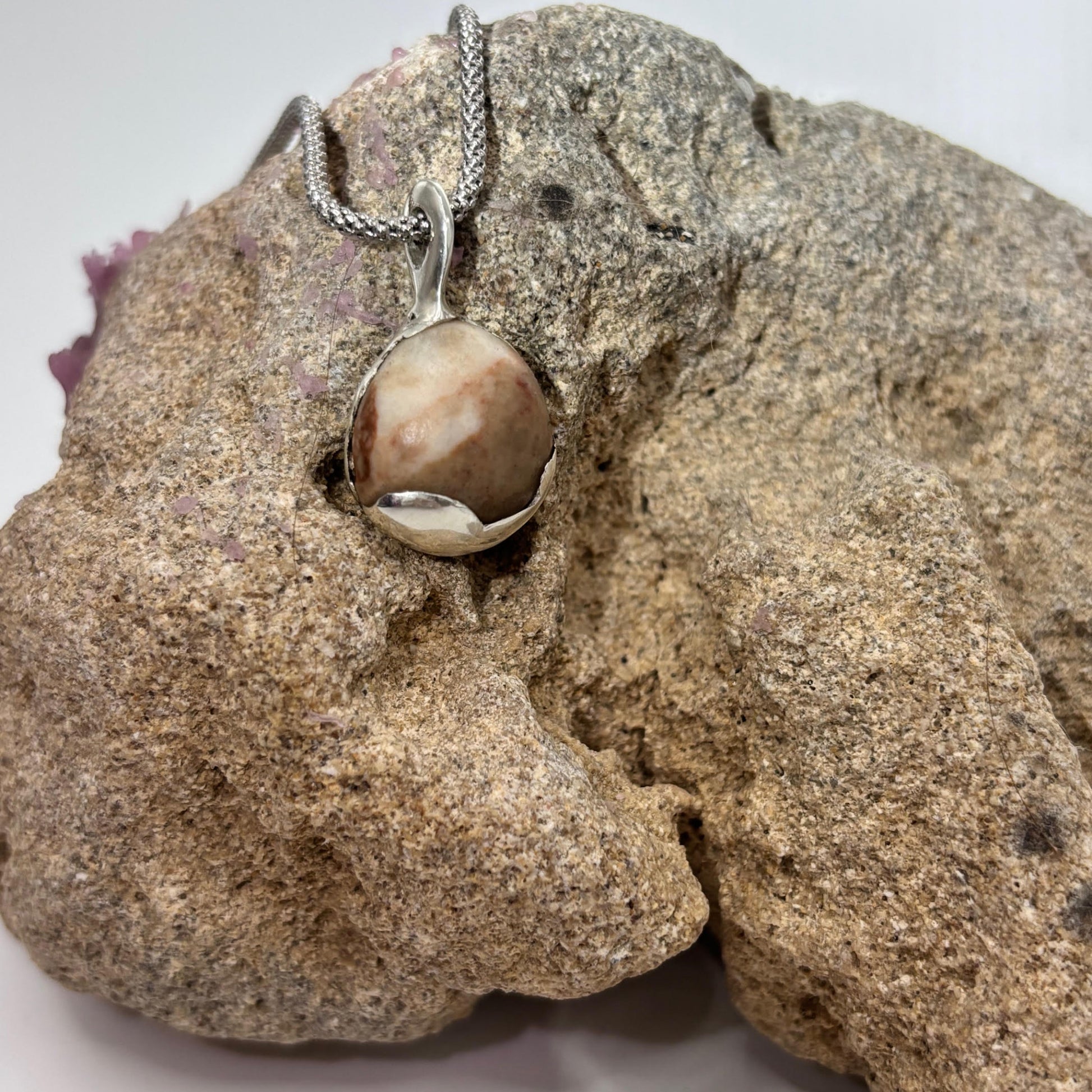 Necklace with a pendant on a textured surface