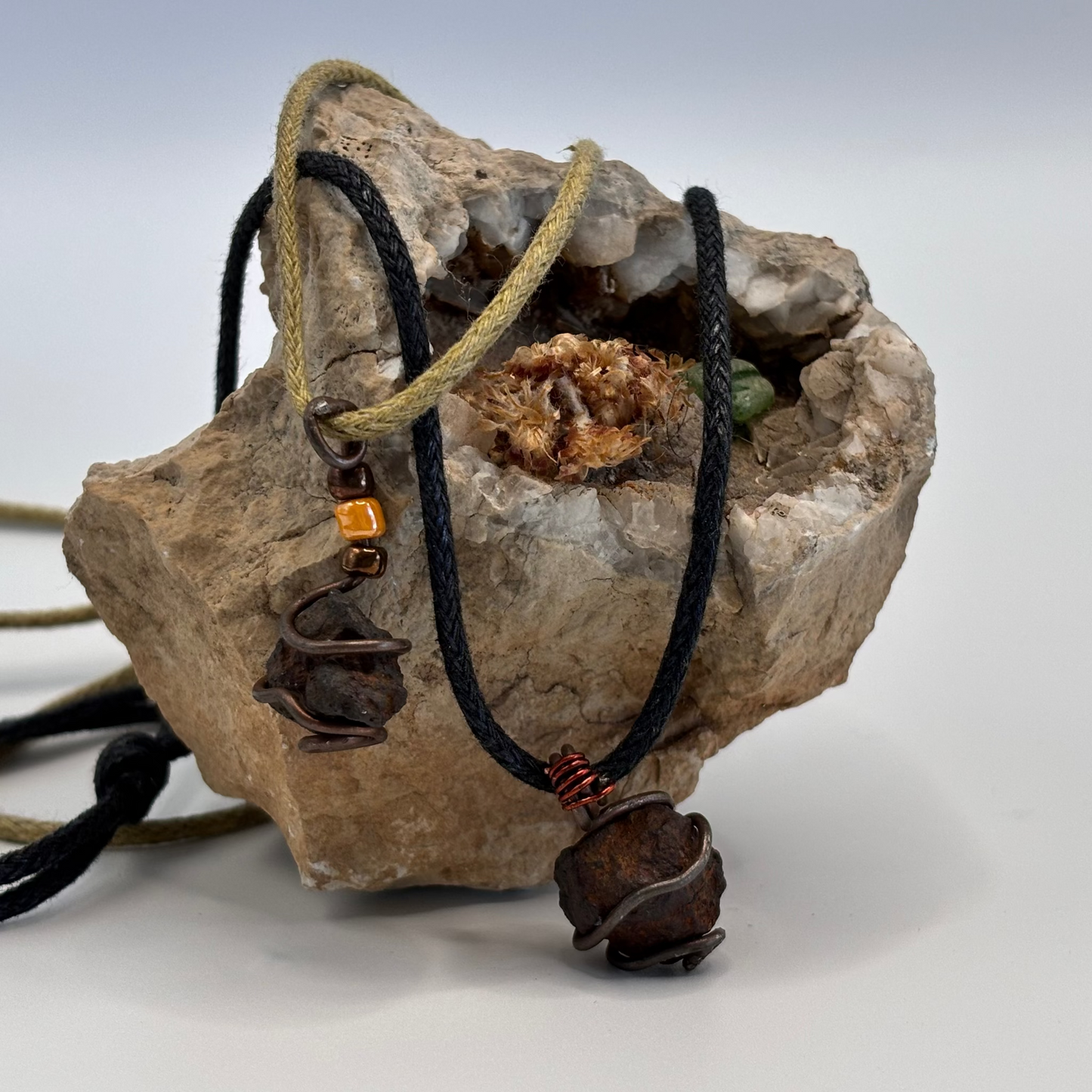 Raw iron stone pendant detail showing wire wrap texture