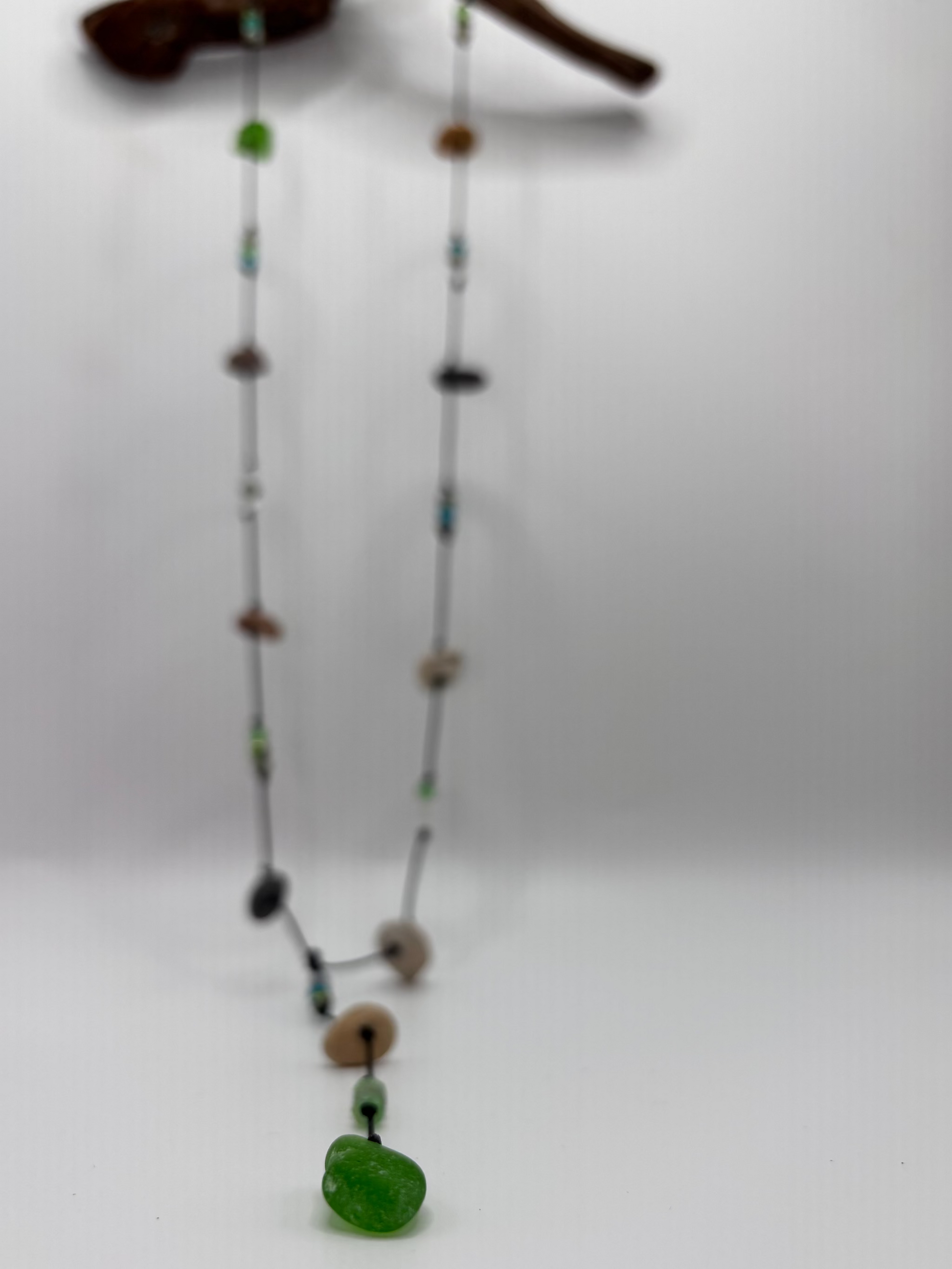 Necklace with various colored beads on a white background
