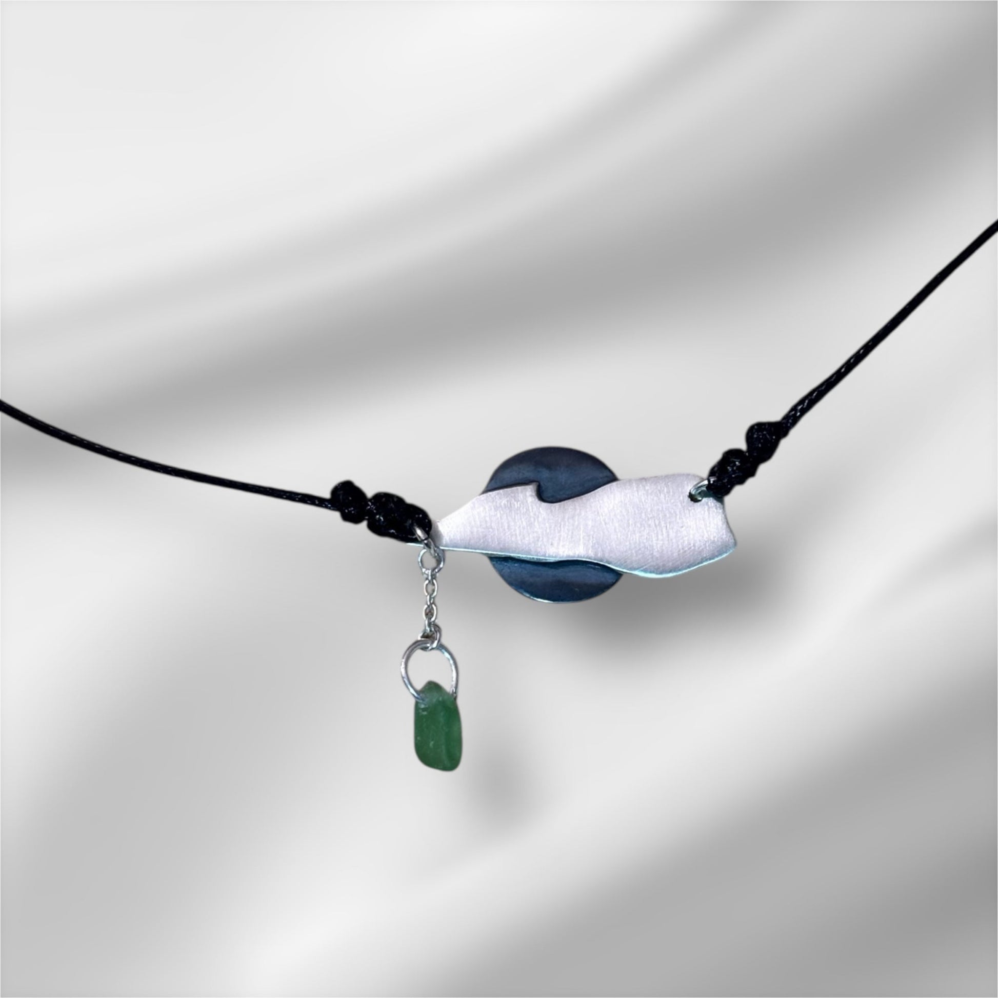 Necklace with a green pendant on a white background