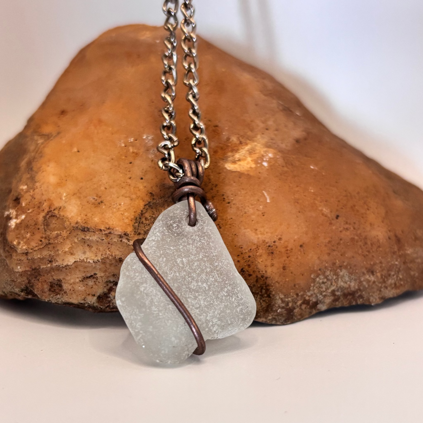 Close-up of copper wire wrapped sea glass necklace