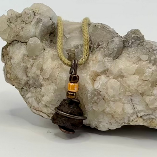 Small raw iron ore pendant wrapped in copper wire necklace