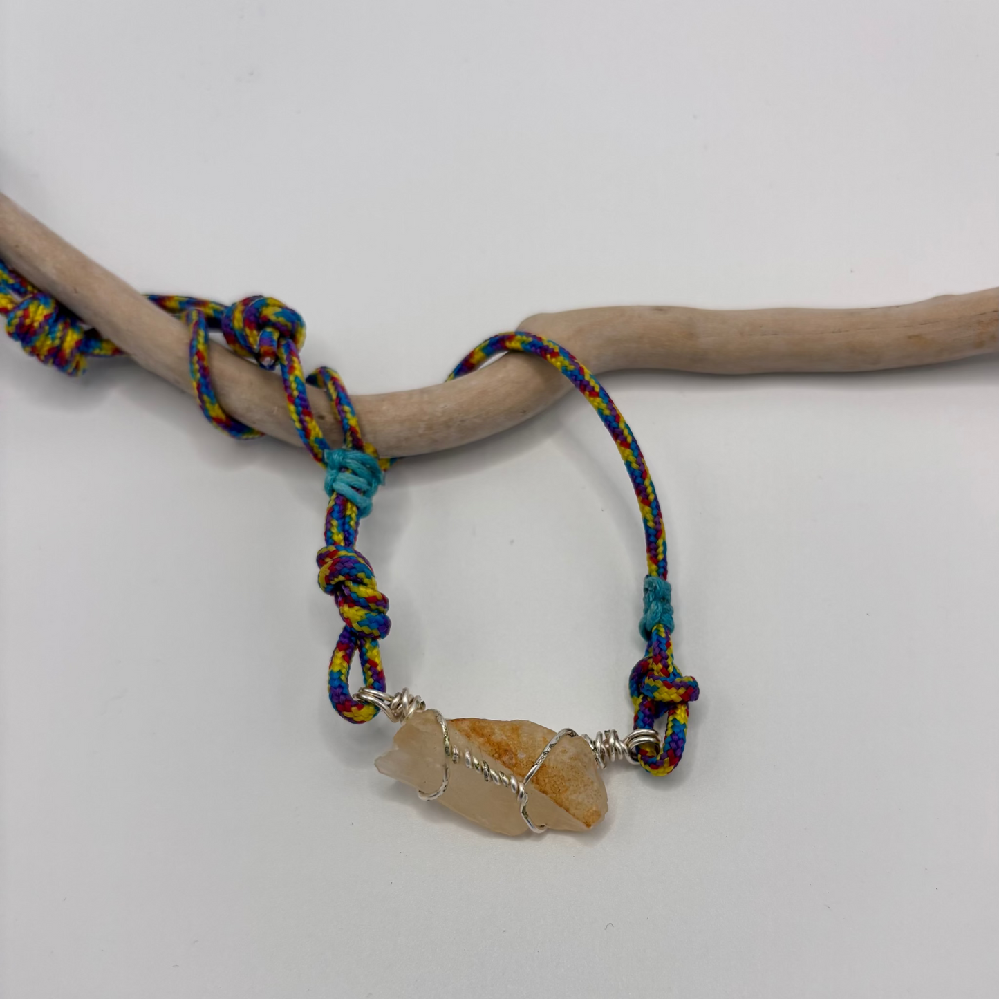 Raw calcite stone wire wrapped pendant on colorful cordelette necklace
