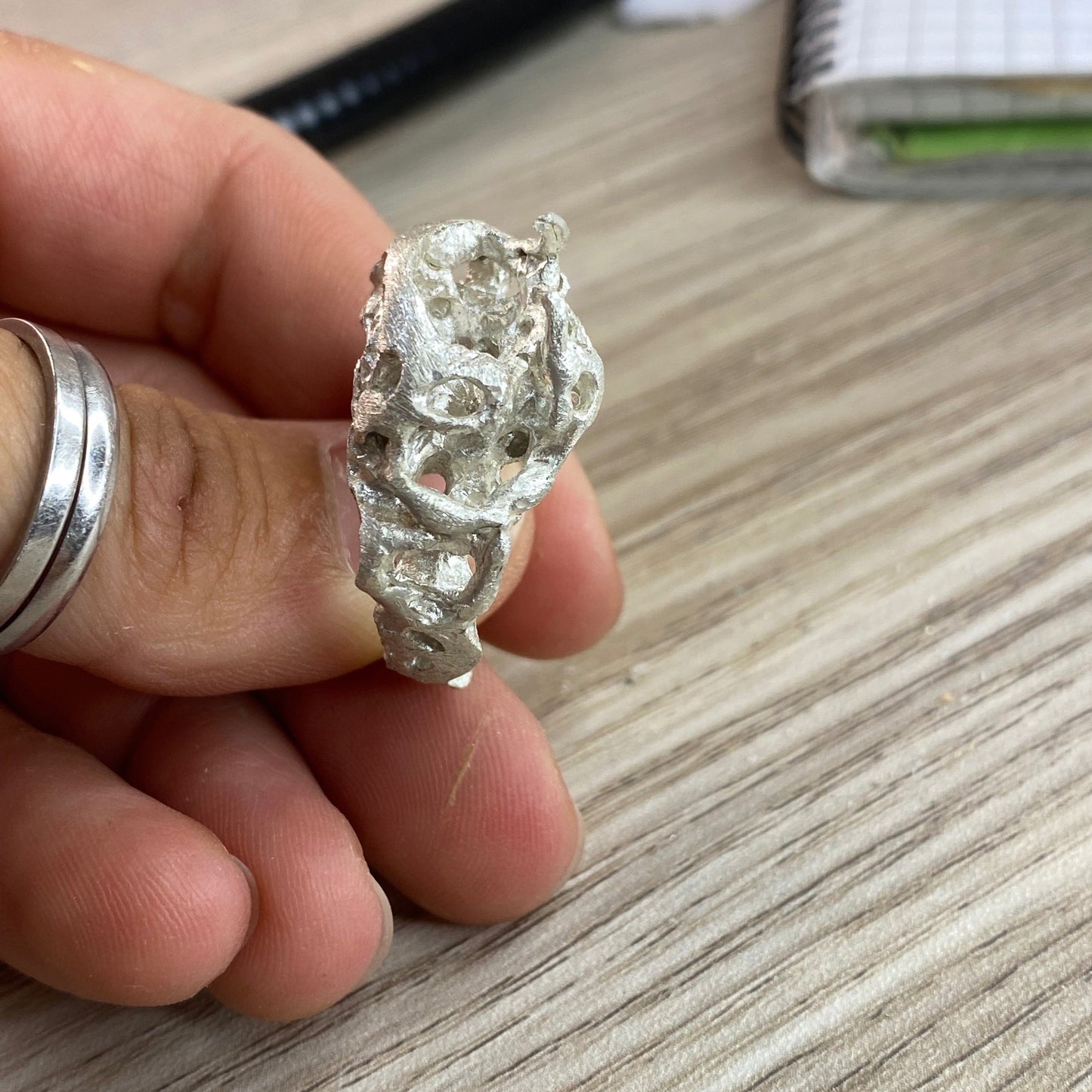 Close-up of the ring's hollow, sculpted silver form