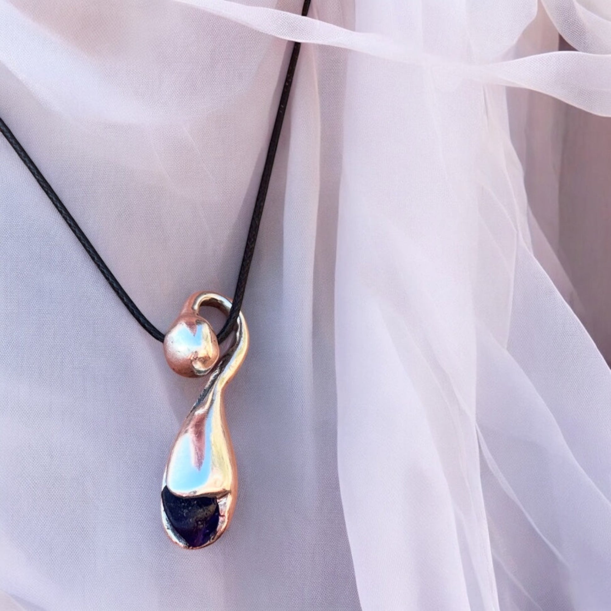 Silver pendant with deep blue sea glass, nature-inspired design