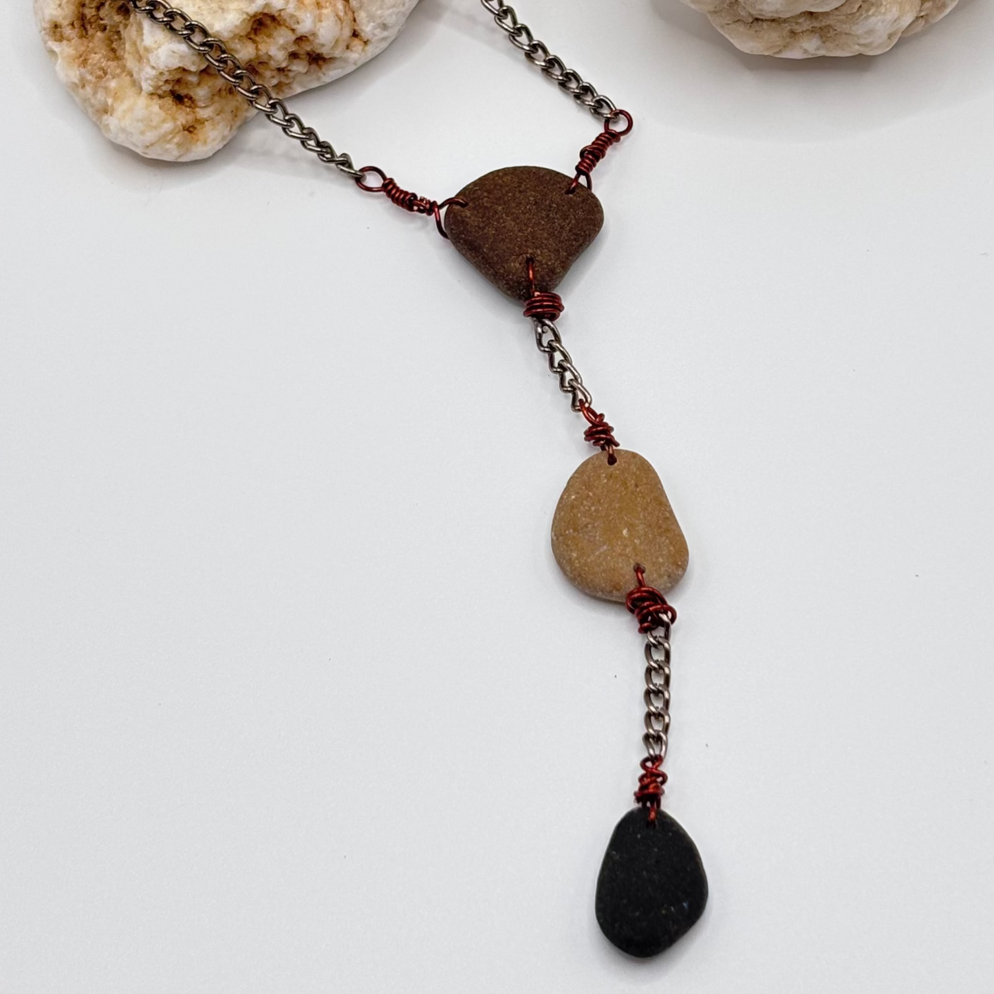 Three raw beach pebbles in brown, beige and black wire wrapped necklace